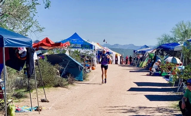 Finalist Stephanie runs through the Javelina 100 Mile headquarters
