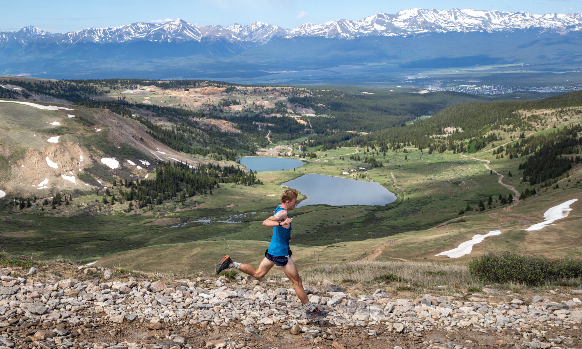 A runner racing on the Leadville trails with beautiful scenery in the background. PC: Life Time