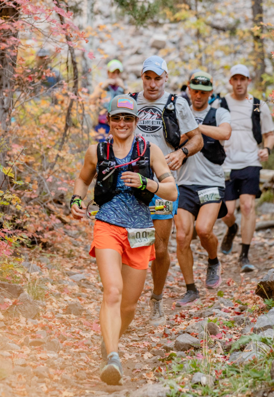 Dandelion running through fall foliage during the Bear 100. PC: Bethany Draper