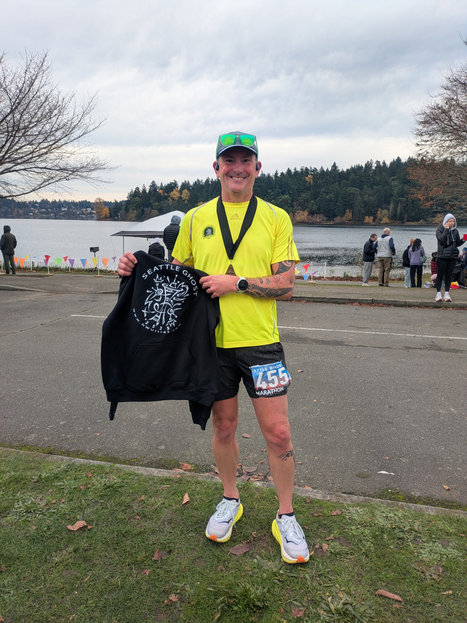 TRR Coach Michael Linscott after finishing the Seattle Ghost Marathon with his finisher's medal and race hoodie.