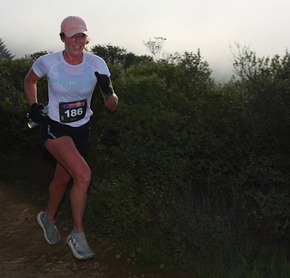 TRR Coach Emily Keddie during the early stages of the Quad Dipsea, with a smile (or perhaps a grimace) on her face. PC: Facchino Photography