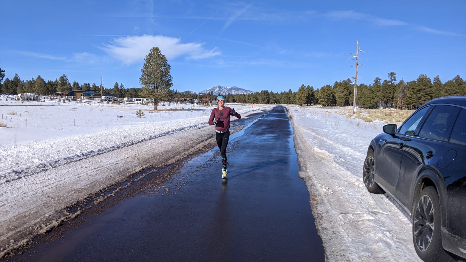 A runner dressed for well for winter running in cold and snowy conditions.
